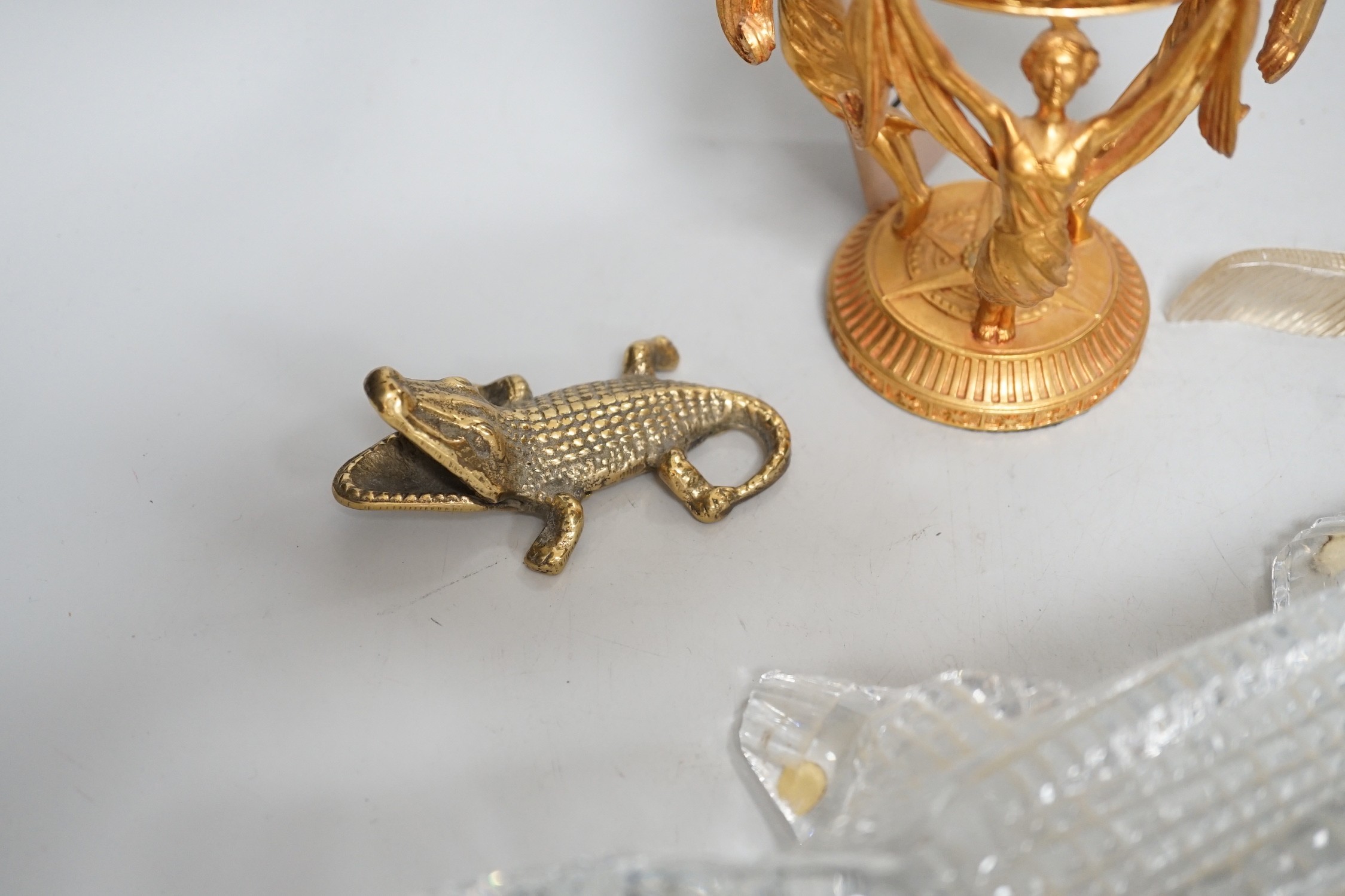A crystal ball on gilt metal stand, 19cm tall, together with a hermatite crocodile, a jade type crocodile and four other crocodiles